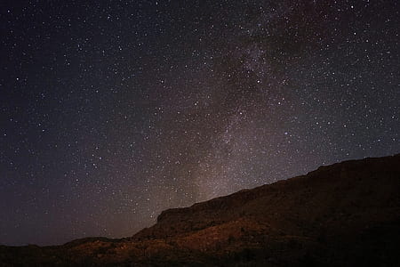 mountain under stars at night time thumbnail
