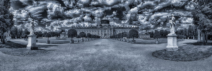 grayscale photography of statue near building thumbnail
