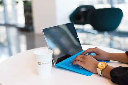 Person Browsing on Black and Blue Laptop Computer thumbnail