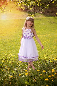 girl standing on flower and grass field while closing her eyes thumbnail