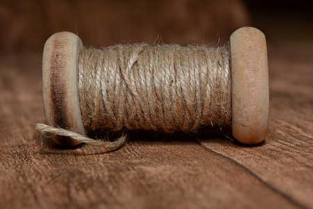 brown thread spool in closeup photography thumbnail