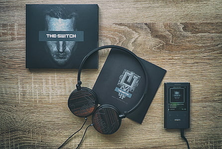 flat lay photography of Android smartphone, headphones, and The Switch box thumbnail
