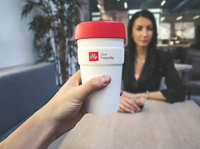 Person Holding White and Red Live Happilly Cup thumbnail