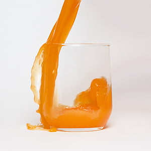 clear rock glass filled with orange liquid thumbnail