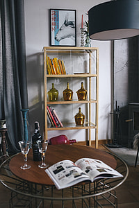Stylish home decor with a wooden round table and a bookcase thumbnail