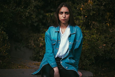 woman sitting on concrete surface thumbnail