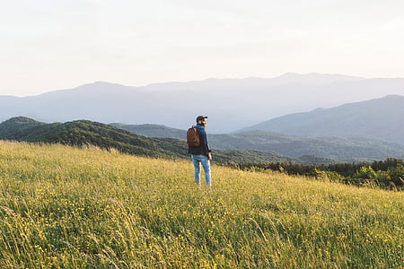 man standing on green field thumbnail