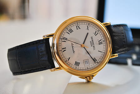 Round Gold-colored Analog Watch With Black Leather Strap at 10:10 thumbnail