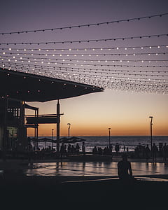 silhouette of people in front of beach during sunset thumbnail