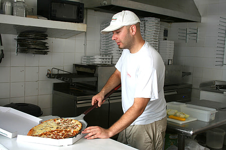man putting pizza on box thumbnail