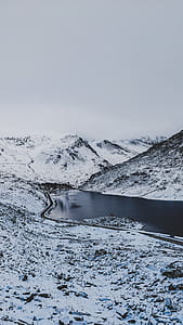 grayscale photography of river surrounded of valley thumbnail