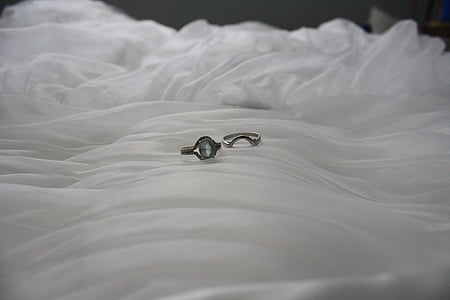 silver-colored bridal ring set on white cloth thumbnail