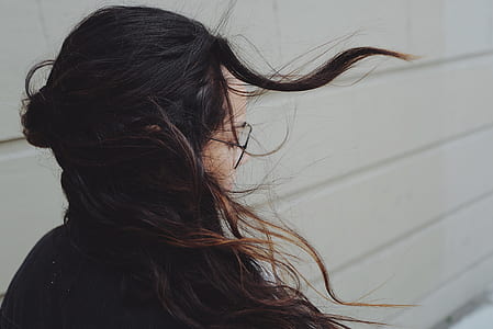 woman standing beside wall wearing eyeglasses and black blouse thumbnail