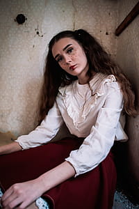 Brown Haired Woman Wearing White Long-sleeved Shirt and Red Skirt thumbnail