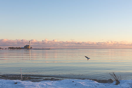 body of water under white sky at daytime thumbnail