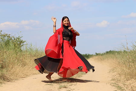 woman wearing black and red dress between grasses photo thumbnail