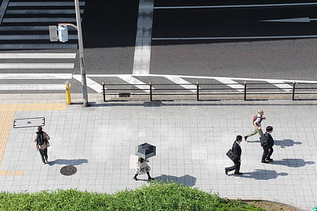 people walking on sidewalk near building thumbnail