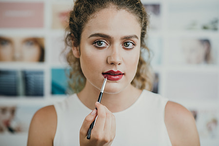 woman putting red lipstick thumbnail
