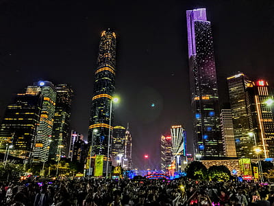 landscape photography of people gathering outside high-rise buildings thumbnail