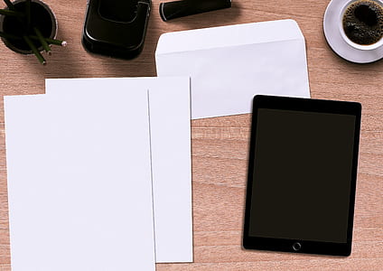 flat lay photography of space gray iPad beside papers thumbnail