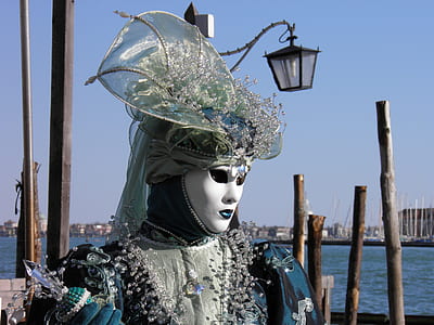 person wearing masquerade mascot near body of water at daytime thumbnail