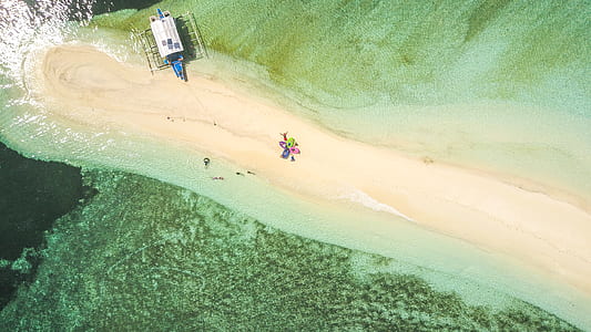 aerial photo of house near water during daytime thumbnail