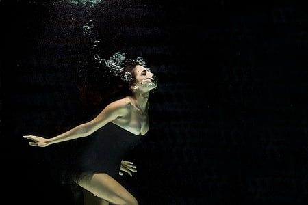woman wearing black strapless dress underwater thumbnail