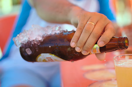 person holding amber glass bottle thumbnail