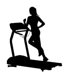 Silhouette of woman running on treadmill. thumbnail