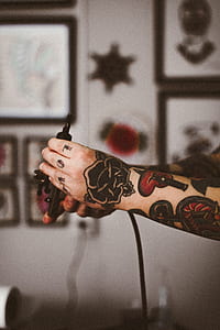 person holding tattoo gun thumbnail
