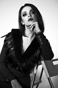 grayscale photo of woman in v-neck feather-accent long-sleeved dress thumbnail