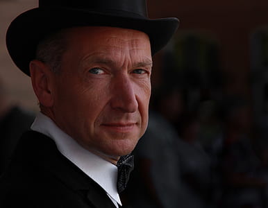 man looking at camera wearing hat thumbnail