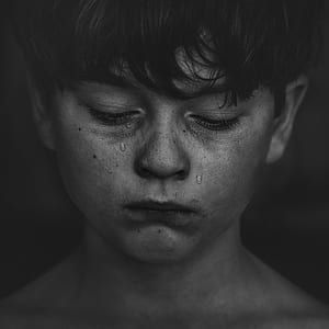 grayscale photo of crying person thumbnail