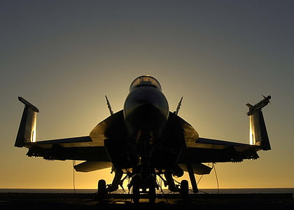 silhouette photography of fighter jet thumbnail