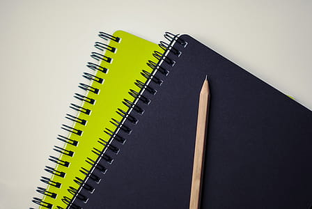 Brown Pencil on Black and Green Book thumbnail