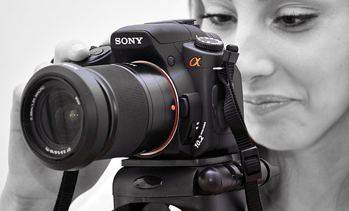 selective color photography of black Sony Alpha DSLR thumbnail