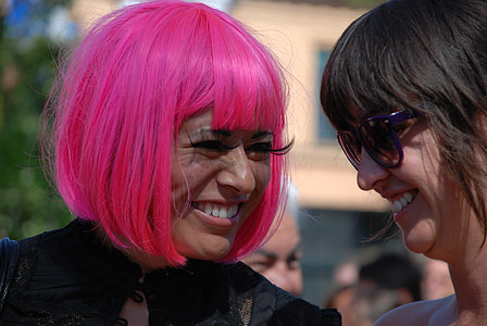 smiling woman wearing pink hair wig thumbnail