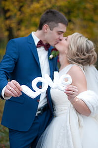 Newly Wed Couple Kissed Each Other While Holding Love Cutout thumbnail