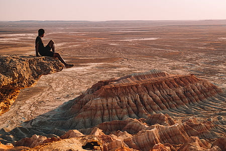 man sitting on rock thumbnail