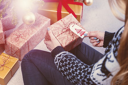 Close-up of female hands unpacking a present. Merry Christmas thumbnail