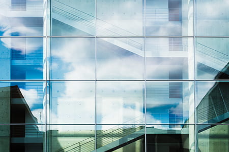 sky and clouds reflected on glass panels thumbnail