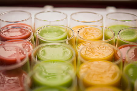 tilt-shift photography of clear glasses filled with liquids thumbnail