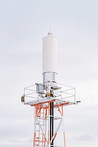 white and orange tower under white clouds thumbnail