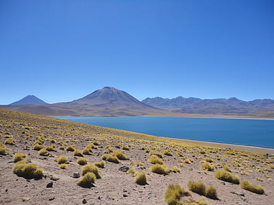 mountains near blue body of water thumbnail