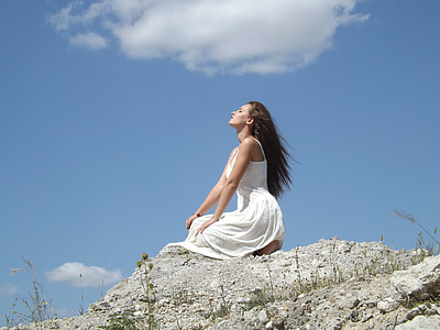 woman in white sleeveless dress looking at sky during daytime thumbnail