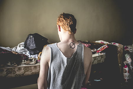 man sitting near mattress thumbnail