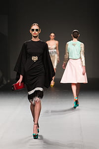 woman wearing black dress holding a red wallet thumbnail