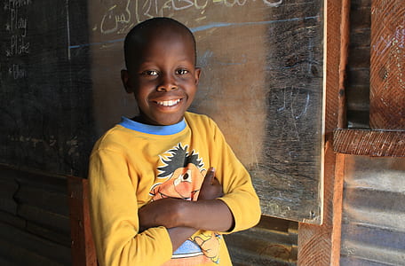 boy standing beside chalkboard thumbnail