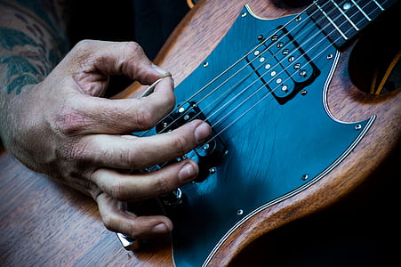 person playing brown SG guitar thumbnail