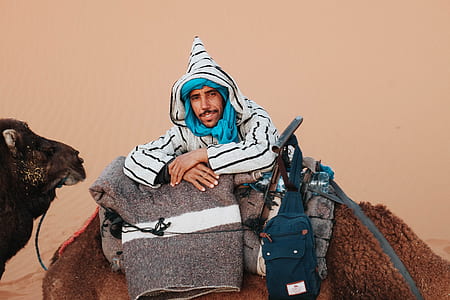man sitting on brown textile thumbnail